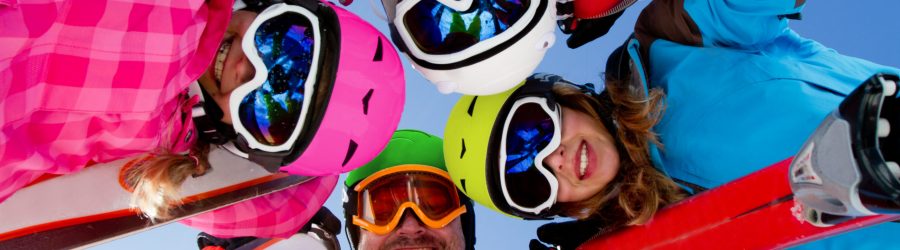 Skiing, winter fun - happy family ski team